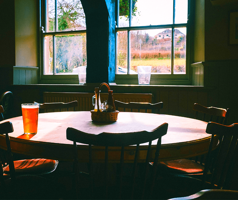 glass of beer at an empty table